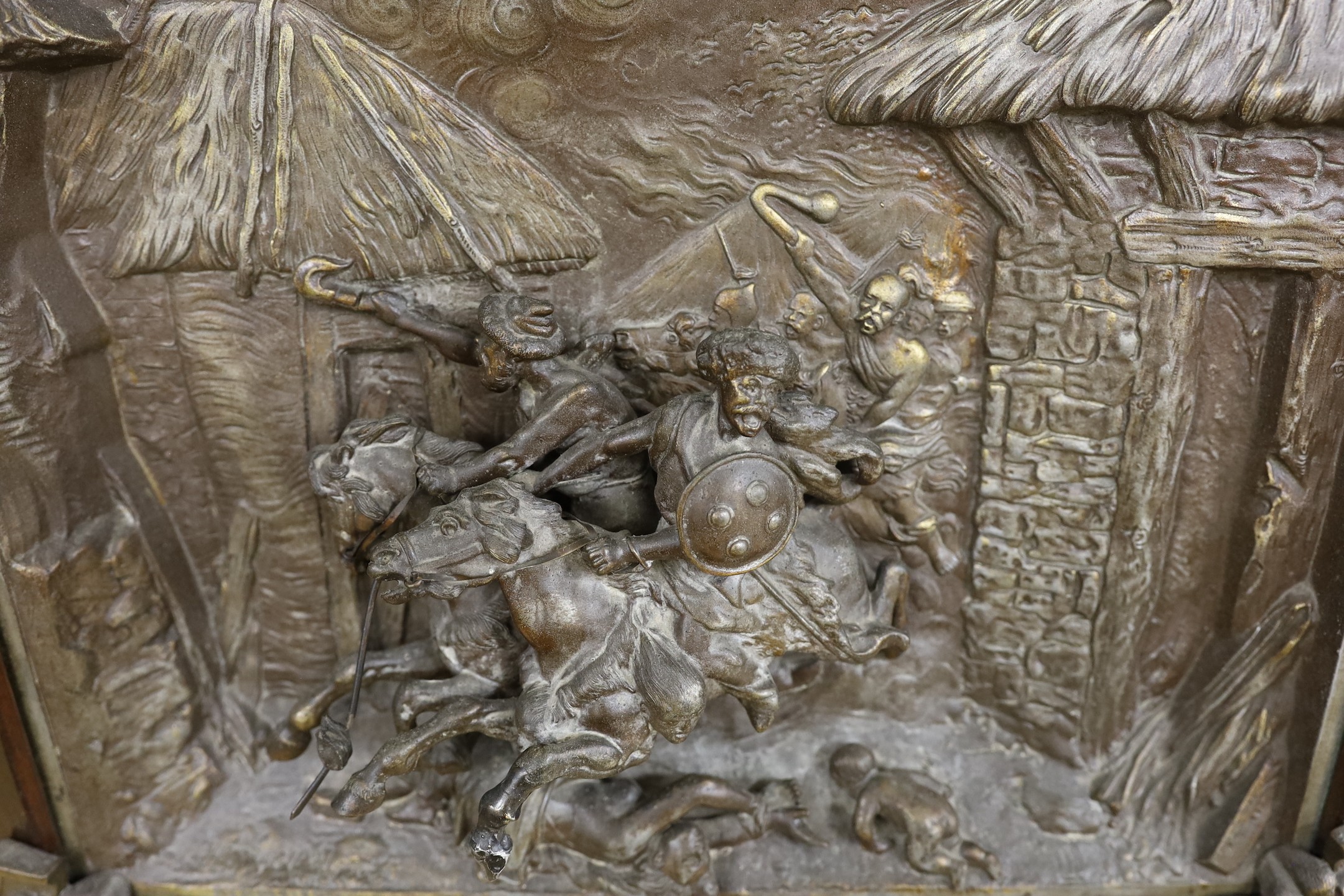 A framed spelter relief plaque, of the Mongols in battle, 59cm wide 51cm high, including frame